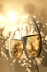 An image of two Champagne glasses on light bokeh background